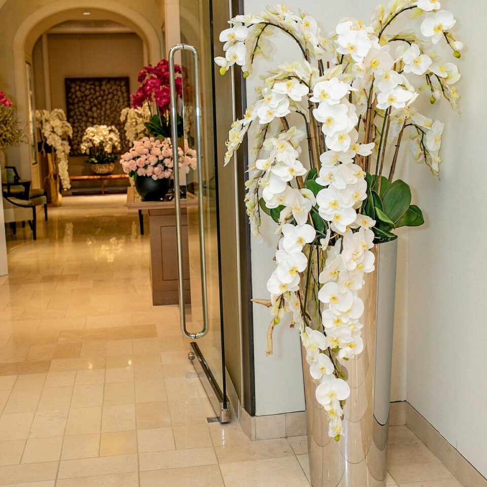 Cascading Phalaenopsis Orchids in a polished stainless steel cone