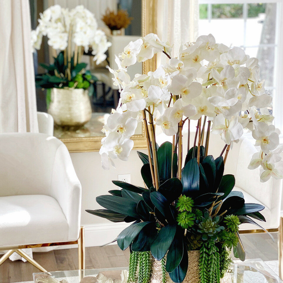 Delaney Gold Vase with multiple stems of Phalaenopsis orchids and succulents.